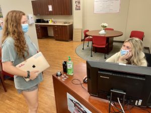 Two students talking at Academic Resource Center Desk 